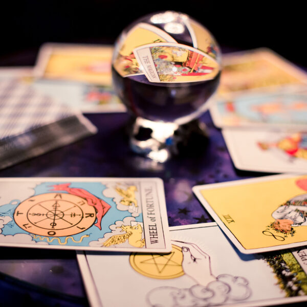 Tarot cards spread on a table surrounding crystal ball